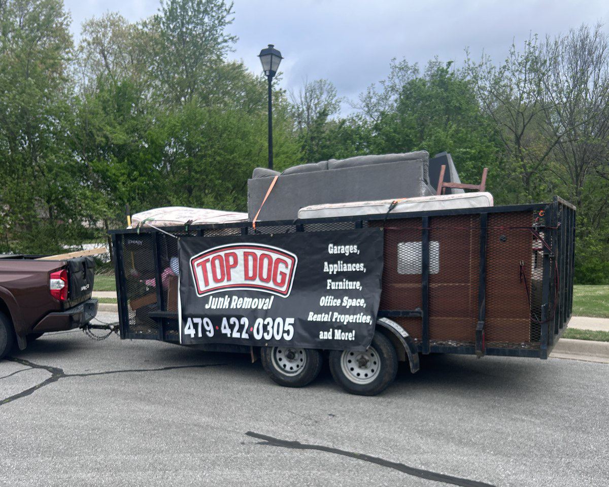 Top Dog Junk Removal trailer loaded with furniture and junk